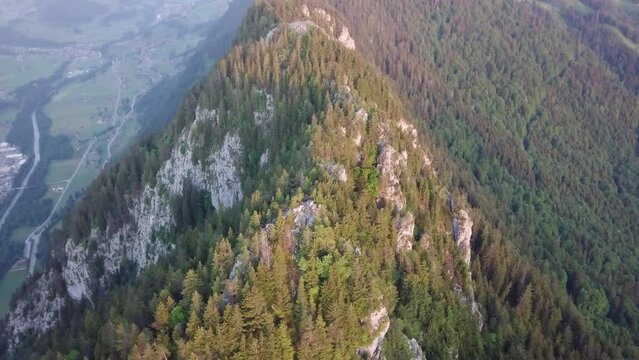 Sunrise behind a mountain peak in Switzerland filmed with a drone