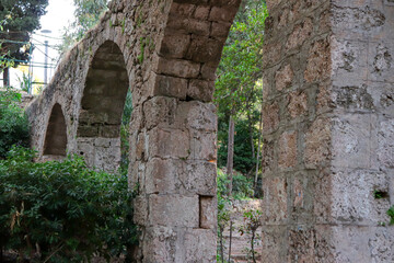 Fototapeta na wymiar Aqueduct, a watercourse arch over the Rodini Park lake and walking path located in central Rhodes