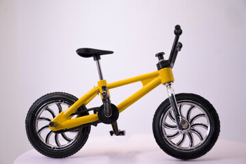 Fototapeta na wymiar Yellow toy bike mockup with black background BMX horizontal