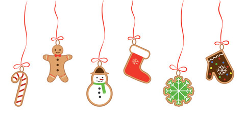 Cookies in the shape of a gingerbread man, a snowman, a mitten, on a ribbon with a bow. Christmas background.