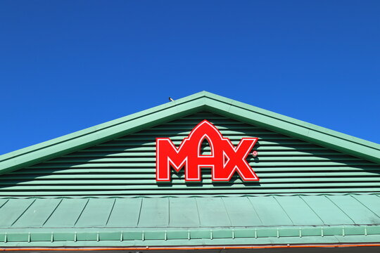One red sign for the Swedish hamburger restaurant Max. Clear blue sky in the background.