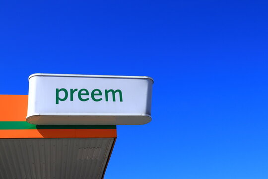 One Preem sign. The logo of a shop and gasoline store. Common in Scandinavia. Nice weather outside. Clear blue sky in the background.