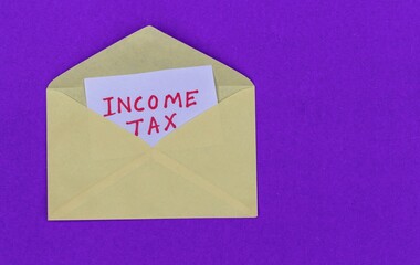Income Tax Notice in Envelope Isolated on Blue Background with Copy Space