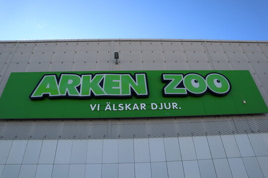 Sign for the Swedish company Arken Zoo. Against a wall to the building. Clear blue sky. Barkarbystaden, Barkarby, Sweden, Europe.