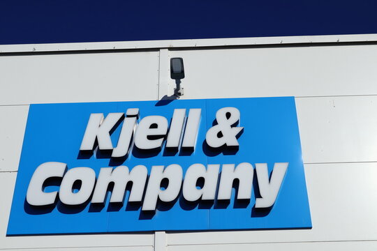 Sign for the Swedish store Kjell and Company. Against a wall to the building. Clear blue sky. Barkarbystaden, Barkarby, Sweden,  Europe.