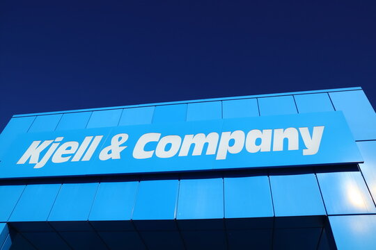 Sign for the Swedish store Kjell and Company. Against a wall to the building. Clear blue sky. Barkarbystaden, Barkarby, Sweden,  Europe.