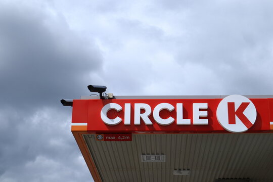 Sign for Circle K. Gas company with store. Worldwide brand, former Statoil. Cloudy background. Safety cameras on top. 