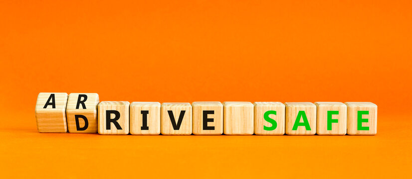 Drive and arrive safe symbol. Concept words Drive safe Arrive safe on wooden blocks. Beautiful orange table orange background. Business drive and arrive safe concept. Copy space.