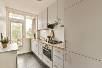 a kitchen with white cabinets and wood counter tops on the counters in front of the sink is seen from the window
