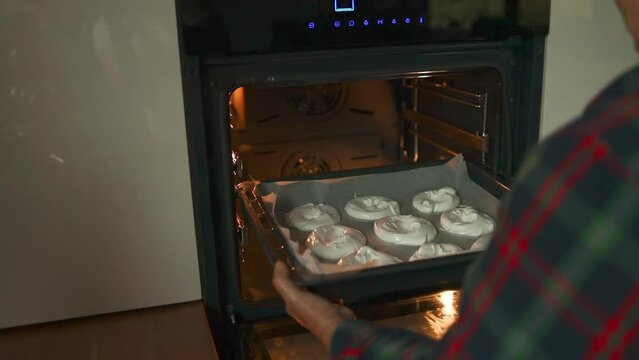 Woman baking white sweet meringues in the oven. White homemade bizet on the baking sheet. High quality FullHD footage