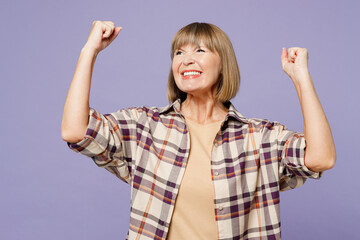 Elderly gray-haired woman 50s years old wear beige t-shirt shirt casual clothes doing winner...