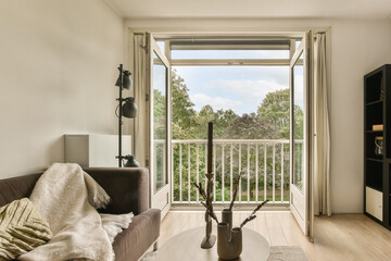 a living room with a couch, coffee table and sliding glass door that leads out to the outside patio area