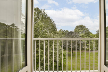 an outside area with trees and grass in the background, taken from inside a window looking out onto a grassy field