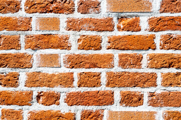 Old weathered red brick wall as background