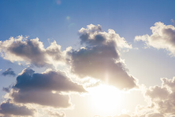 Clouds and sun at sunset. Cloudscape background photo.