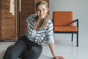 Plus size woman relaxing at home. Positive emotional portrait of a blonde. Relaxation and relaxation