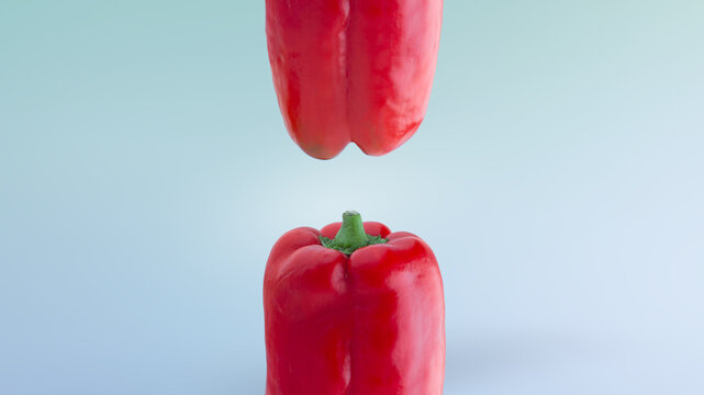 Red bell pepeer on blue background composition. Side view of top and bottom of a red bell pepper 
