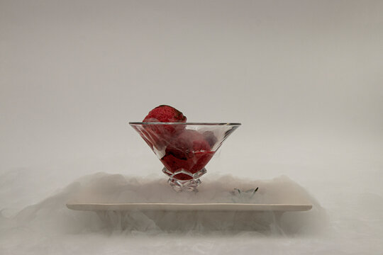 ice cream in a cup, in a white plate in a fog of liquid nitrogen four
