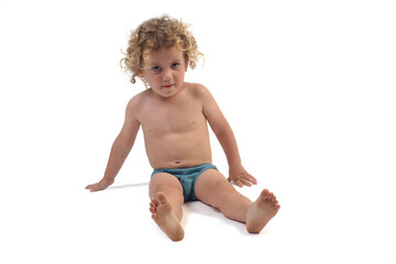 front view of a boy in underpants sitting on the floor looking at camera on white background (3...