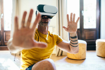 Man in VR headset exercising in light room