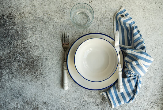 Minimalistic rustic table setting on gray surface