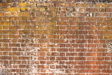 Brick wall made of old red brick. Old, vintage brick wall. Background for designers.