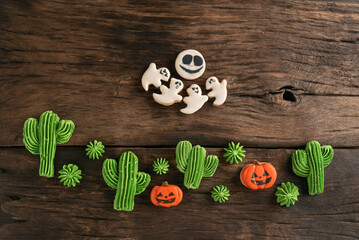 Sweets to celebrate Halloween. Cookies in the form of ghosts cacti and pumpkins Jack-o-lantern on...