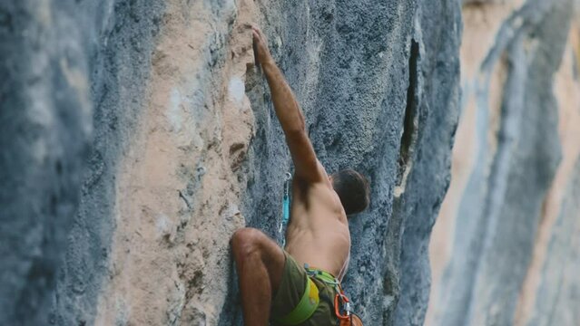 sport climbing. rock climber climbs a rock with a rope and falls on a difficult movement. climber on the route. Sports and safety.