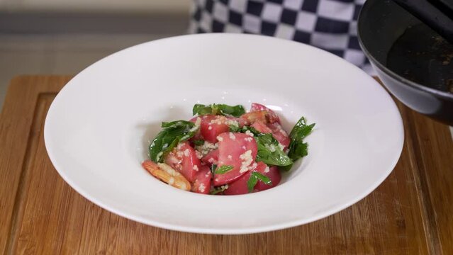 Serving fresh vegetable salad with cuscus and shrimps