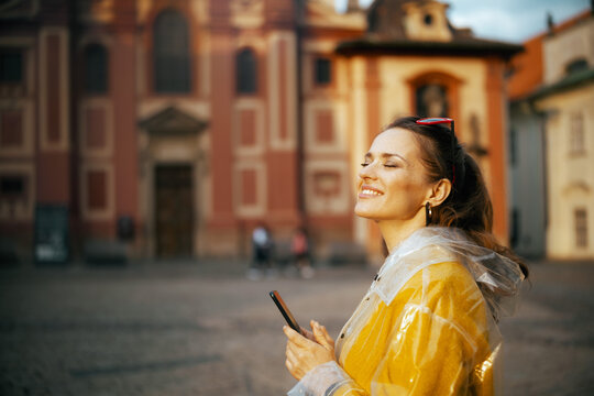 smiling stylish woman in blouse in Prague Czech Republic