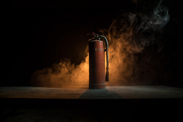 Fire extinguisher on dark background. Fire protection concept. - obrazy, fototapety, plakaty