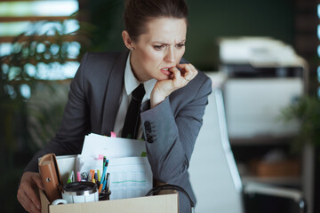 concerned 40 years old woman worker in green office