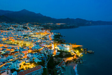 Scenic view from drone of spanish town of Nerja on southern Mediterranean coast at night, Malaga, Spain