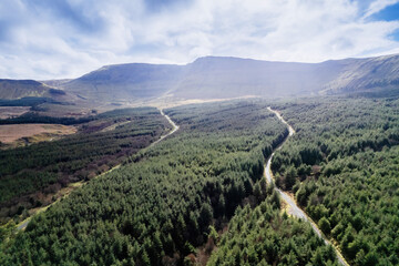 Aerial view on nature scene with green forest by a mountain, cloudy sky. Sligo area, Ireland. Warm...