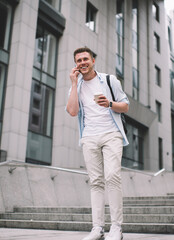 Happy man chatting on phone walking on street