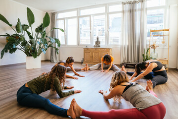 Yoga class stretching sitting in a circle shape