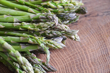 Green asparagus on wooden background