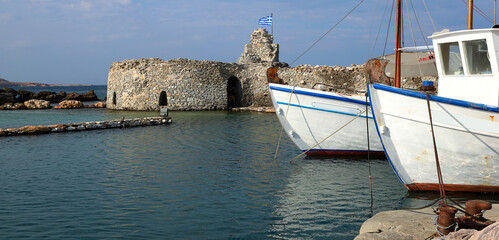 Remains of the old Venetian castle tower guarding the entry of the old fishing harbor at Naousa, Paros.