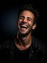 portrait of a man laughing, black background