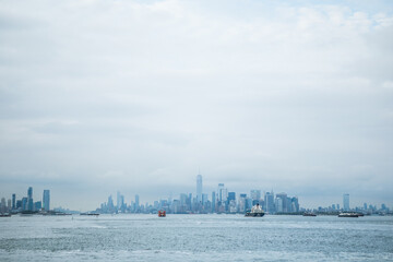 Fototapeta premium Staten island ferry on the hudson river in lower manhattan in New York city on a sunny day, United States.