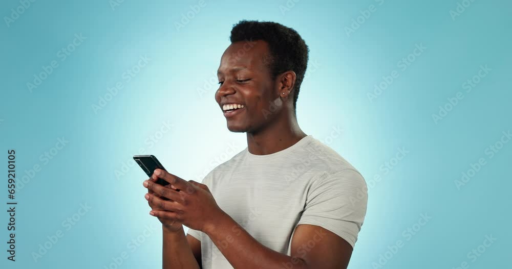 Poster man, smile and texting on phone in studio by blue background for networking, message and social medi