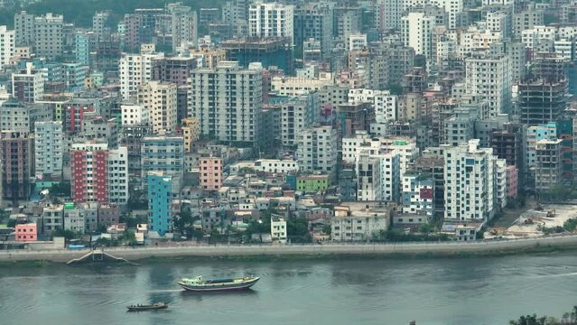 Aerial view of Dhaka city, the vibrant and bustling capital of Bangladesh. The cosmopolitan city is a blend of modern and traditional, with towering skyscrapers, bustling markets. Buriganga