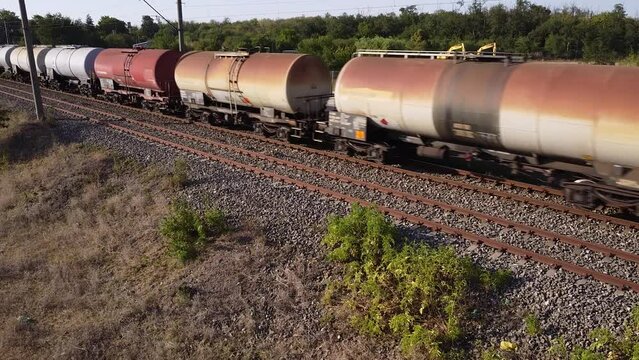 Aerial Drone high angle footage of a freight train of oil cars. DOT-111 fuel railway cars filmed from the air.
