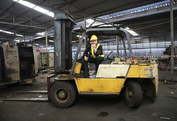 worker or engineer working in factory with safety uniform , safety hat and safety glasses , image is safety concept or happy workplace
