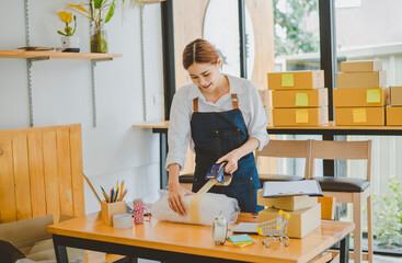 Online small business owners are packing their ordered products into the boxes for their customers based on the concept of online shopping - online shopping.