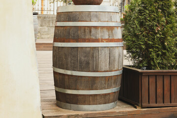 Traditional wooden barrel on street outdoors. Wine making