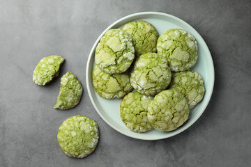 Plate with tasty matcha cookies on grey table, flat lay