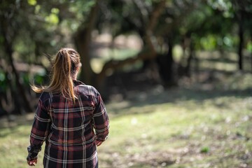 Girl studying a soil and plant sample in field. scientist in a paddock looking for fungi.