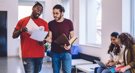 Communicating students in modern hallway