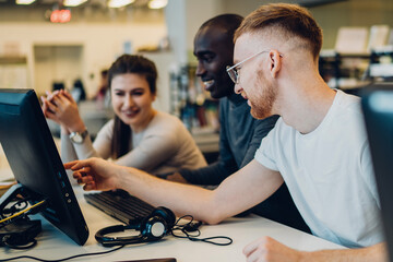 Cheerful students learning in library